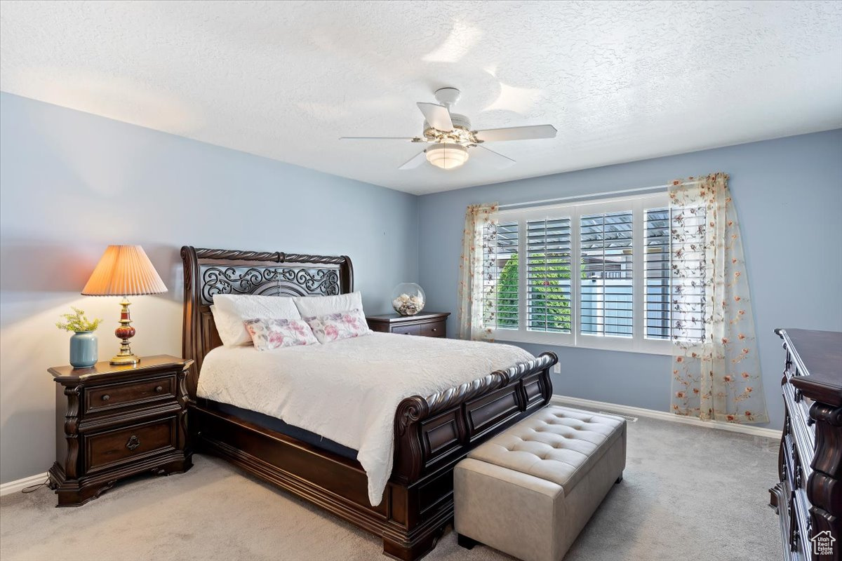 Main floor owner's bedroom with large window view to the secluded back patio.