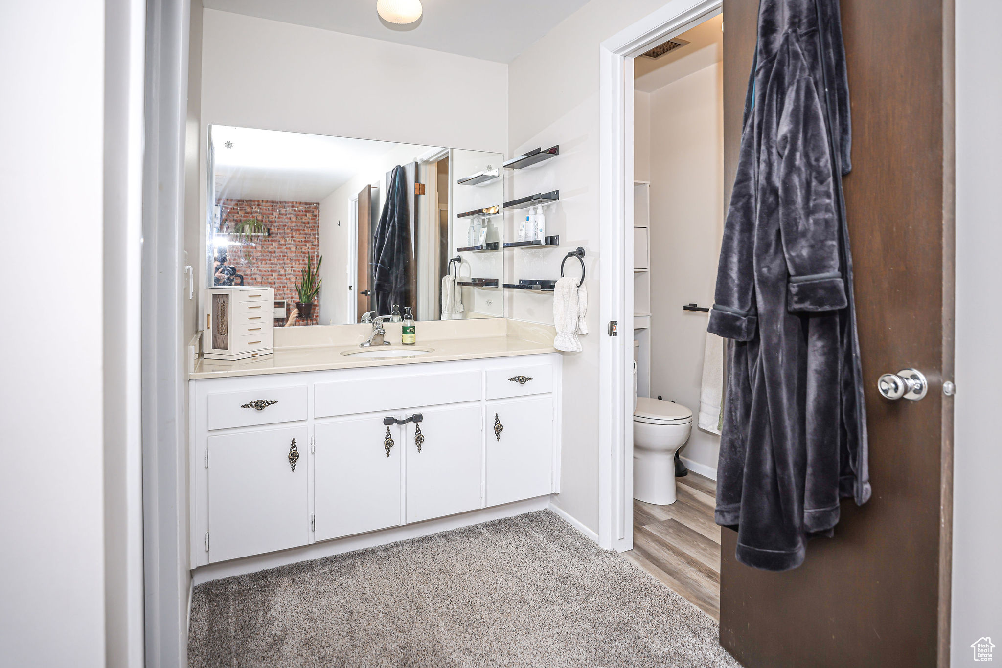 Bathroom featuring vanity, wood-type flooring, and toilet