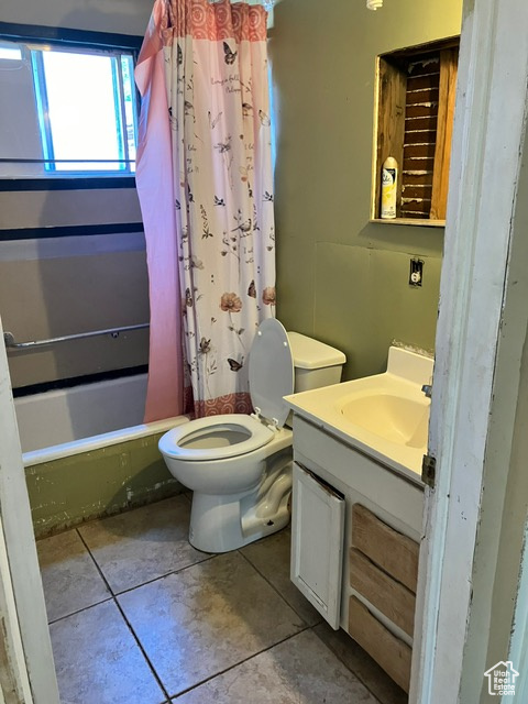 Full bathroom with shower / bathtub combination with curtain, tile patterned flooring, vanity, and toilet