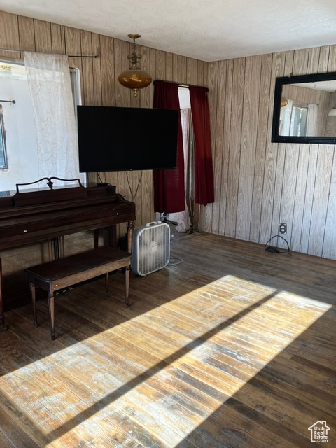 Miscellaneous room with wooden walls and hardwood / wood-style flooring