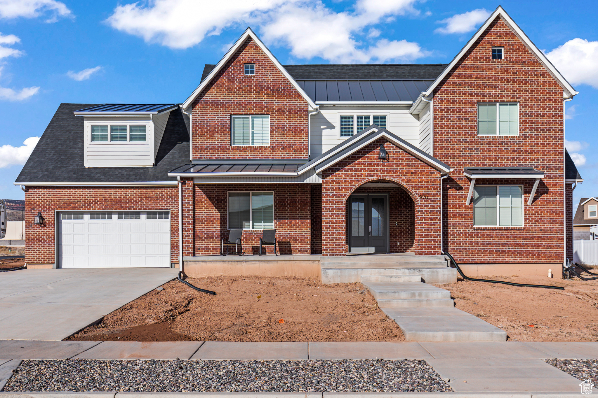 View of front of property with covered porch and a garage