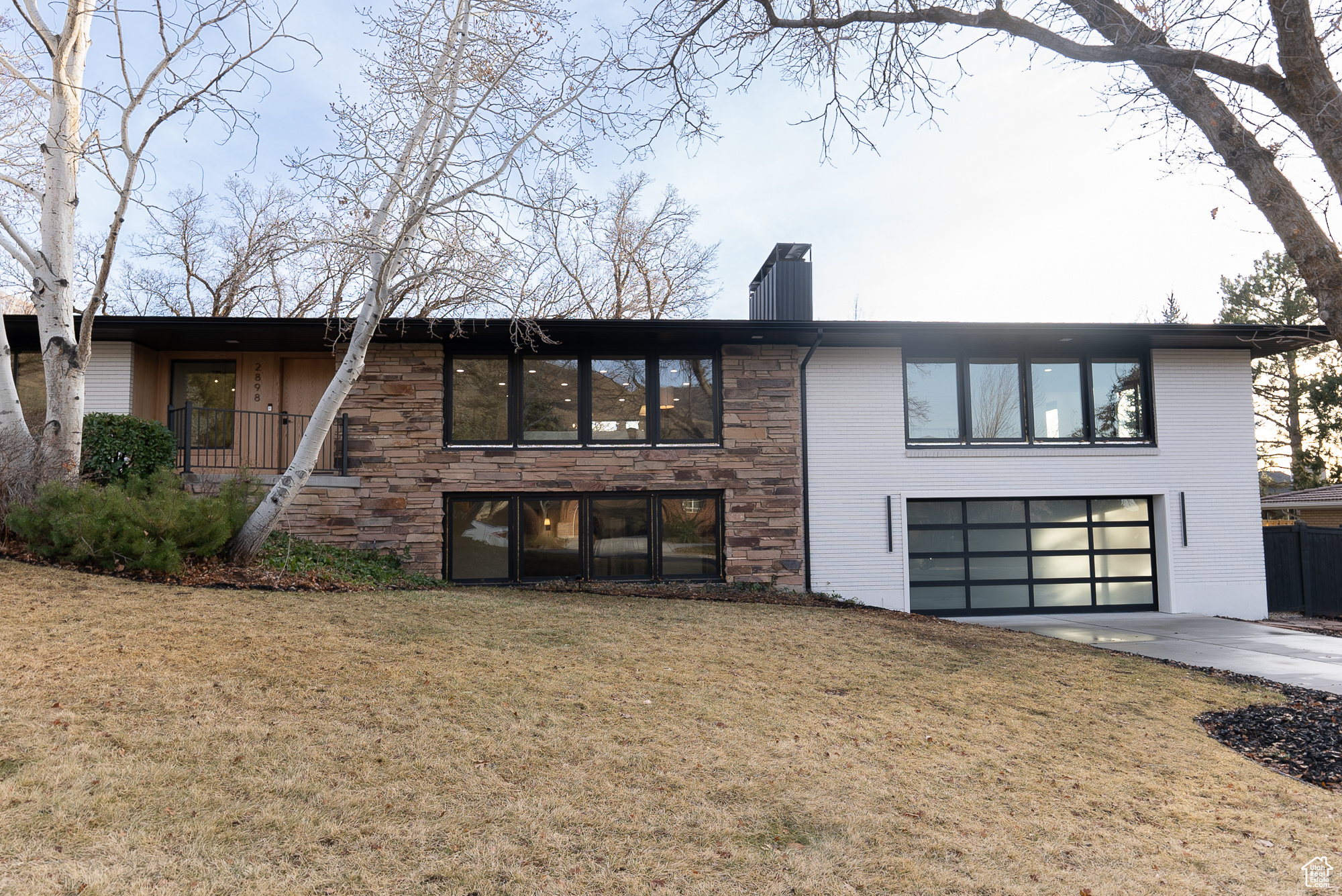 Exterior space with a front lawn and a garage