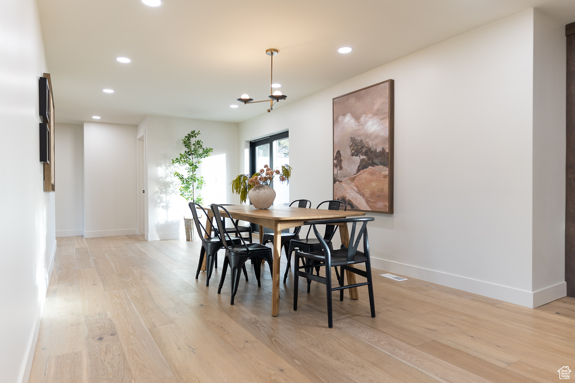 Dining room with a notable chandelier and light hardwood / wood-style floors