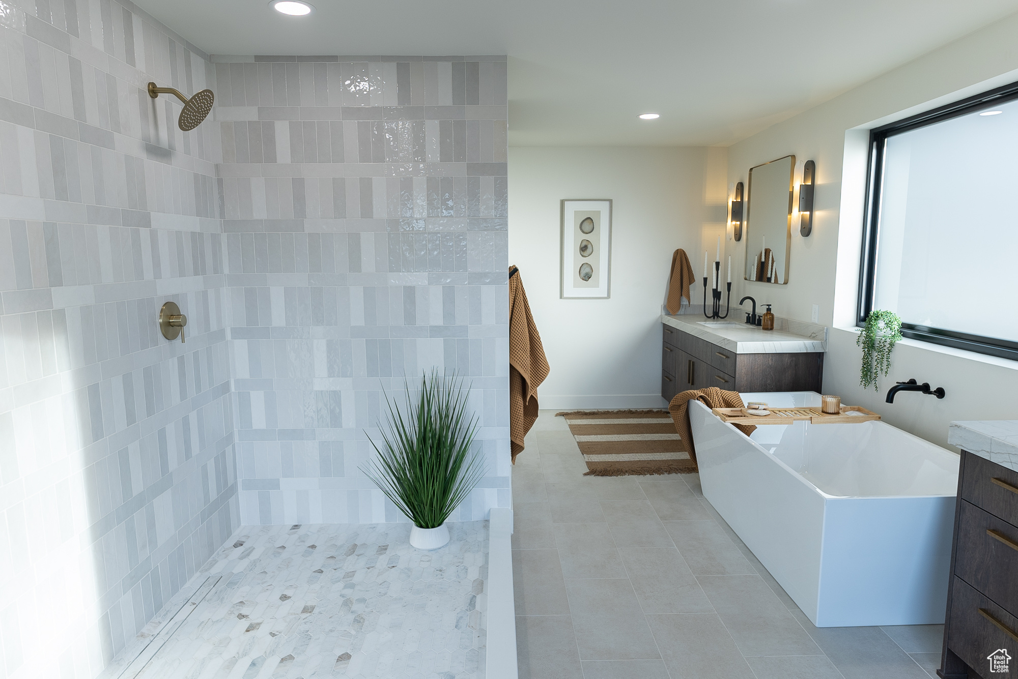 Bathroom featuring shower with separate bathtub and vanity