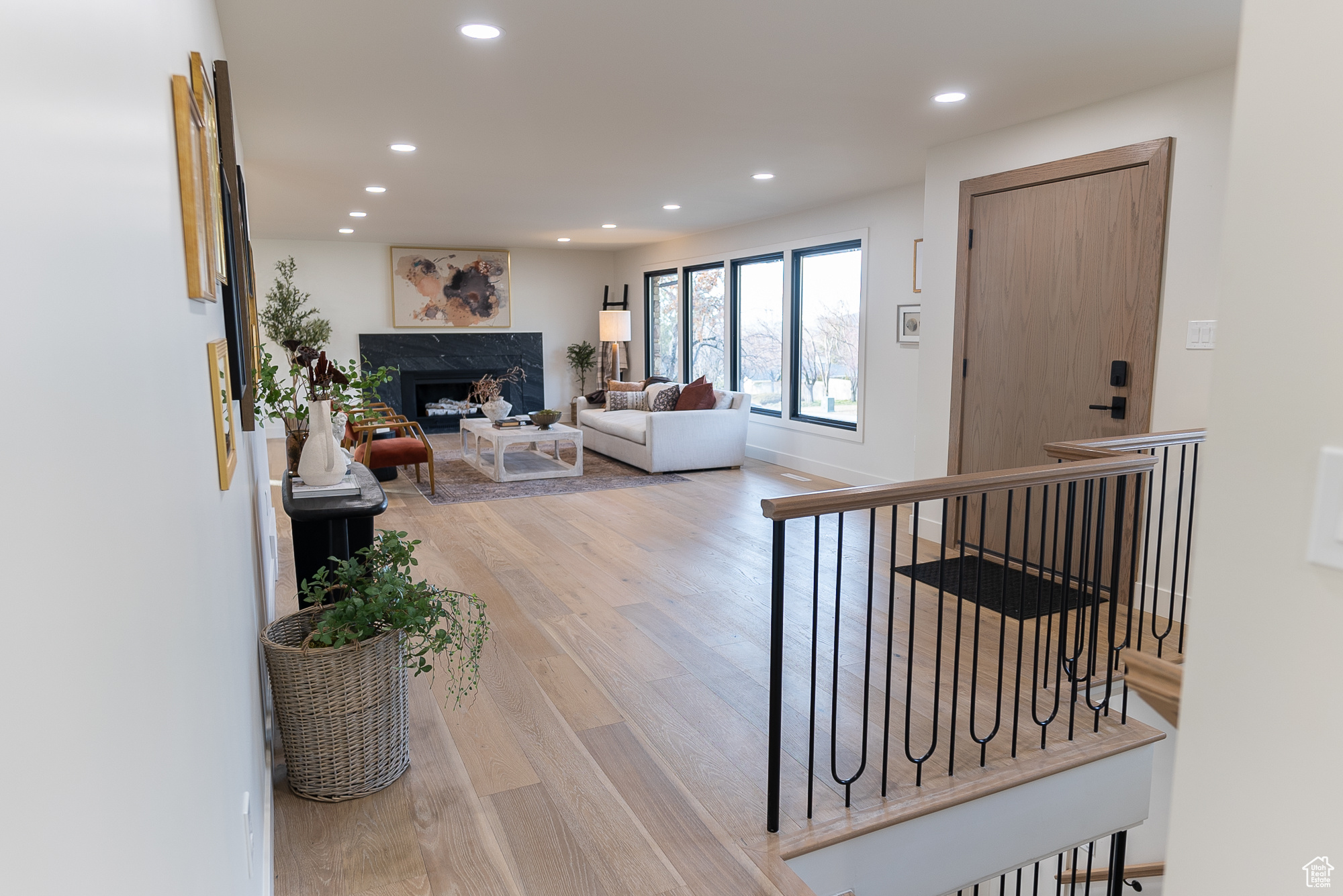 Living room featuring a high end fireplace and wood-type flooring