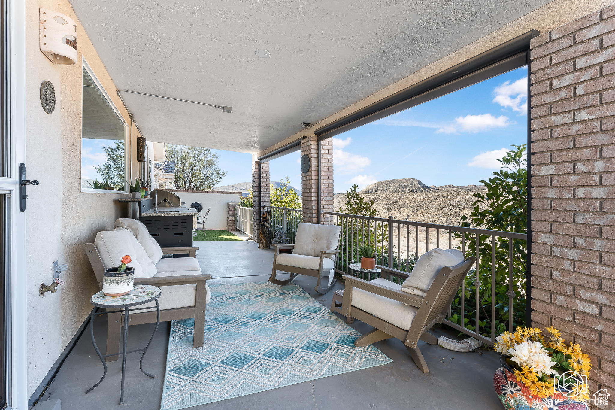 View of patio with a mountain view and a balcony