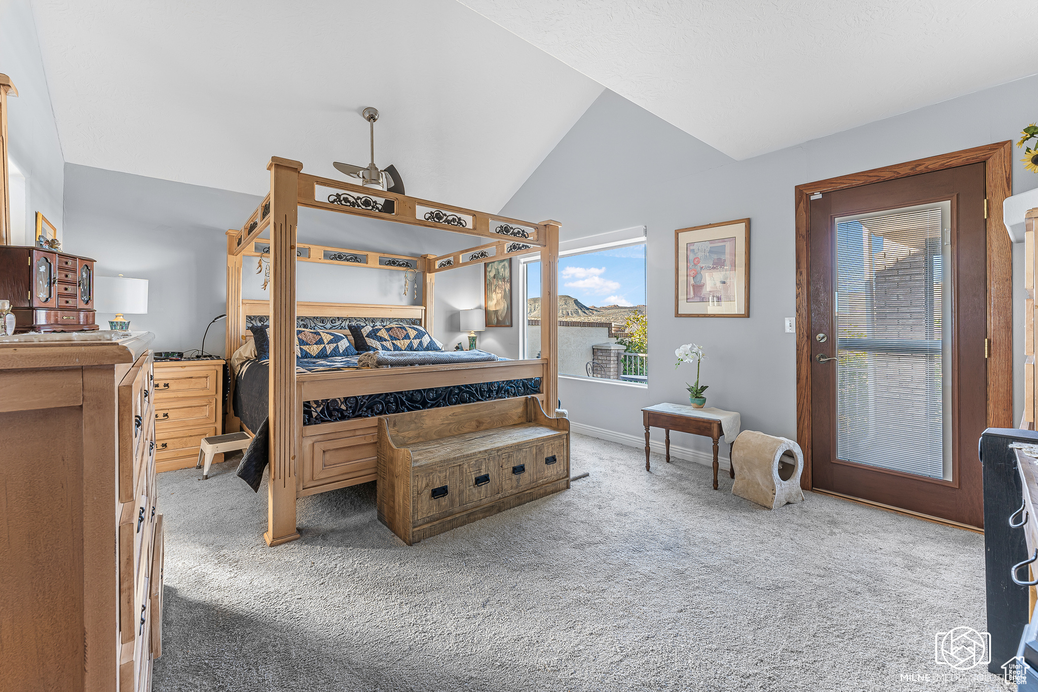 Bedroom featuring carpet and vaulted ceiling