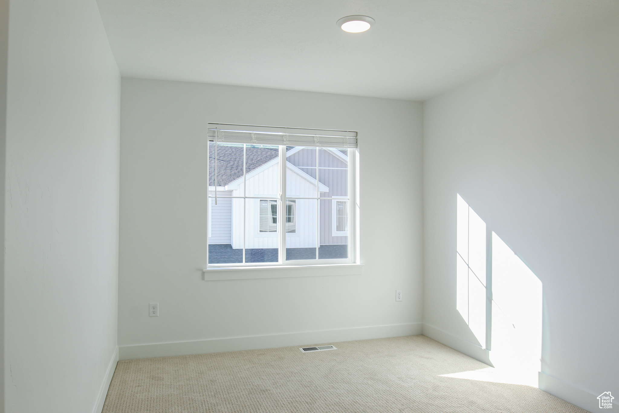 View of carpeted spare room