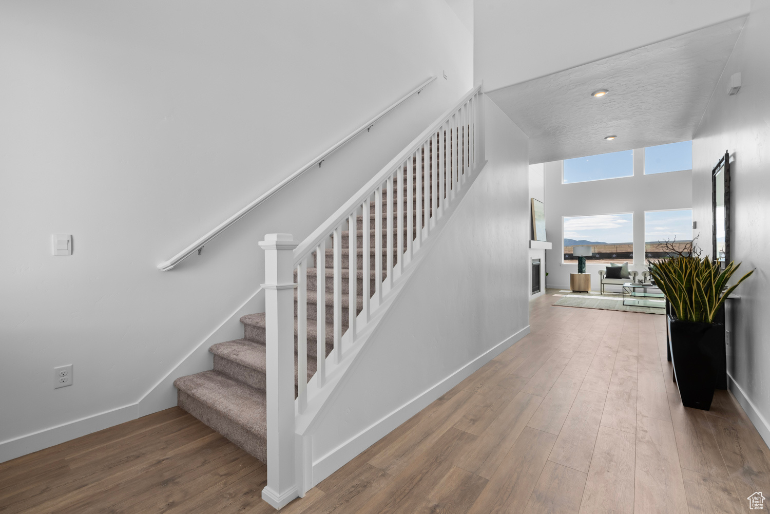 Staircase with hardwood / wood-style flooring