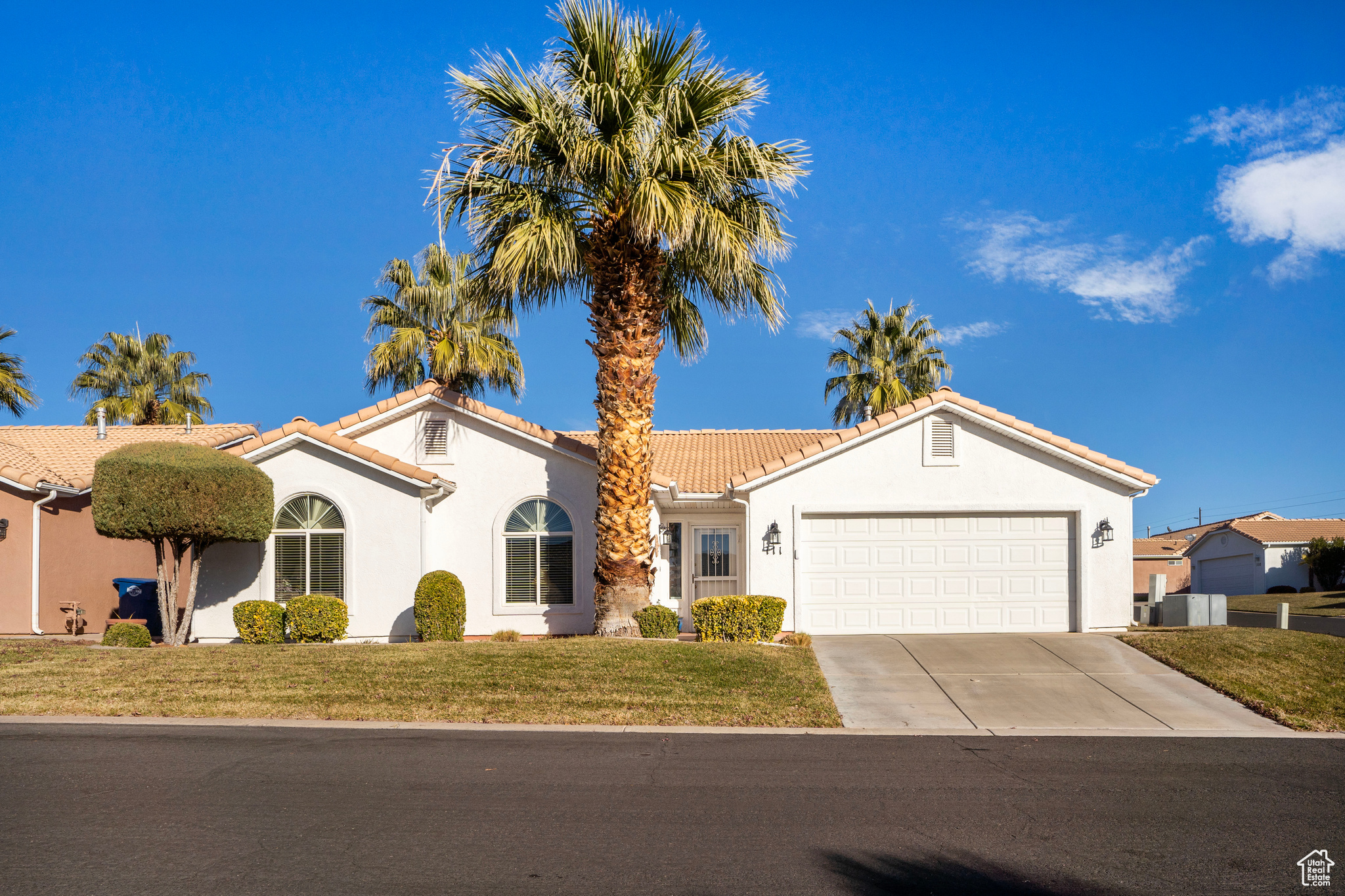 View of front of property featuring a garage and a front yard