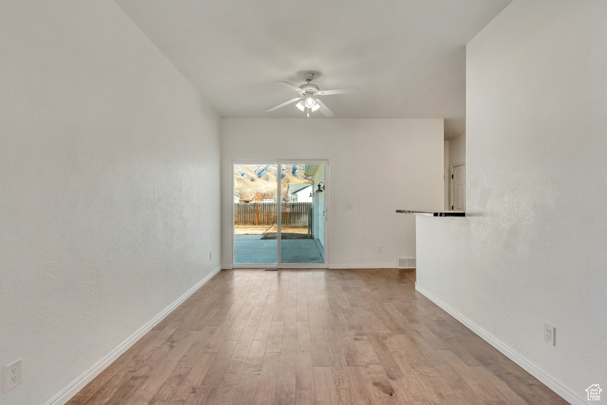 Dining room with light wood-type flooring and ceiling fan