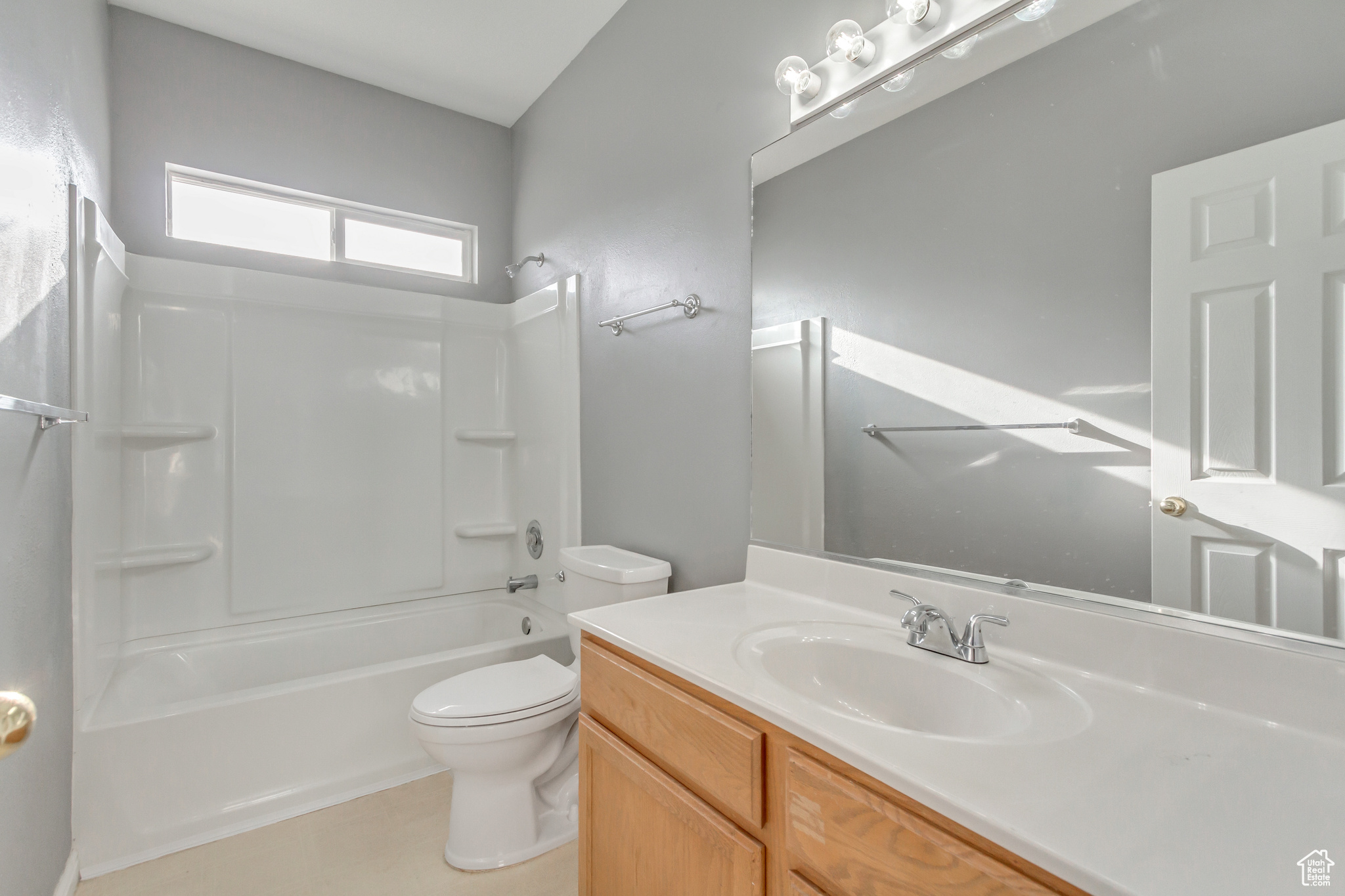 Full bathroom with vanity, toilet, and tub / shower combination