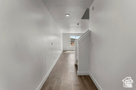 Hallway with hardwood / wood-style flooring