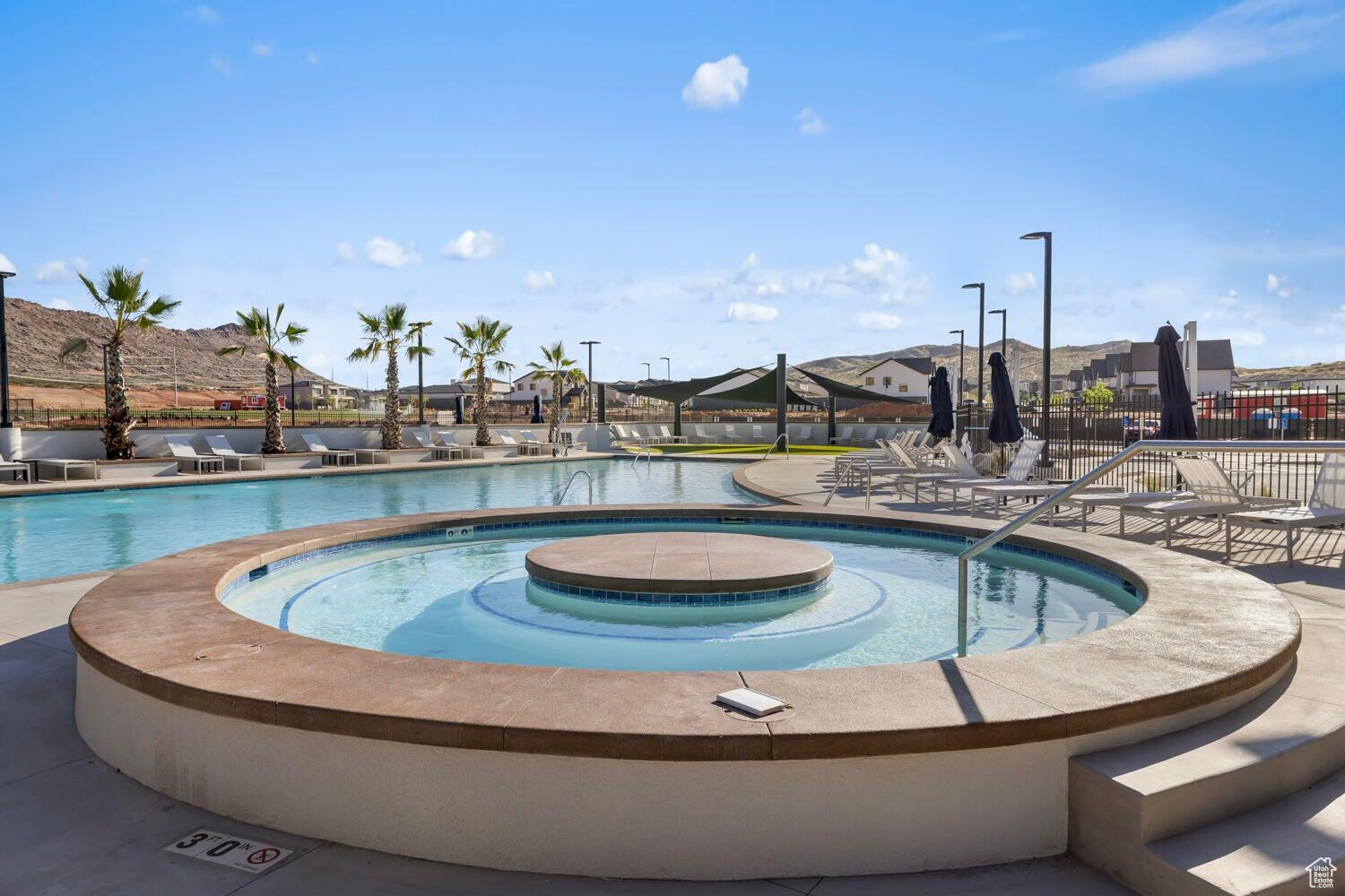 View of pool featuring a hot tub