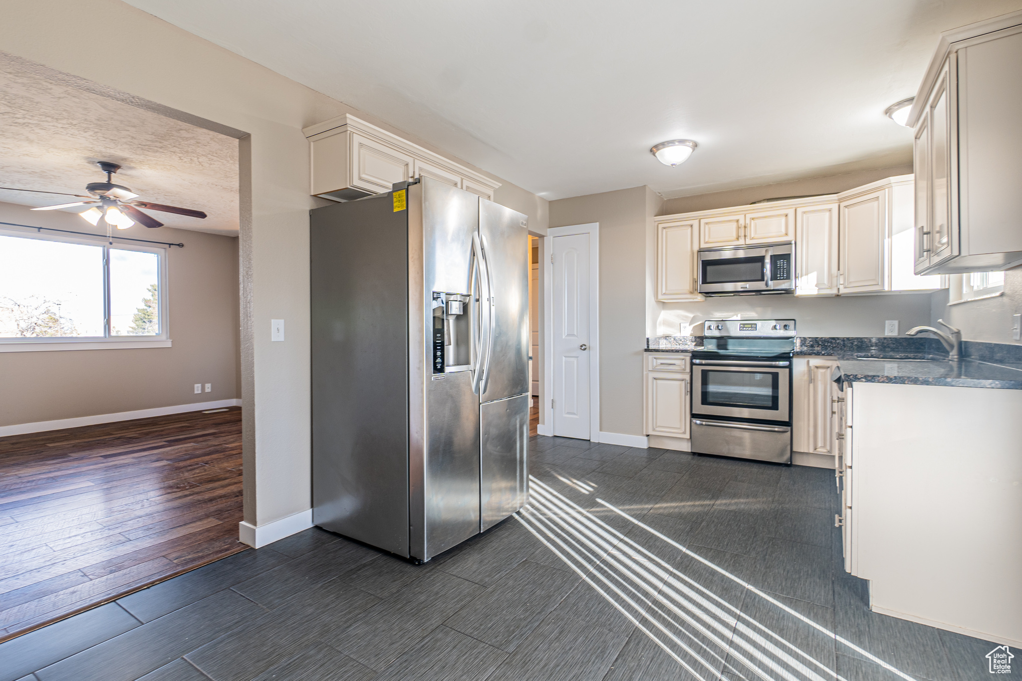 Kitchen featuring appliances with stainless steel finishes with view of front room