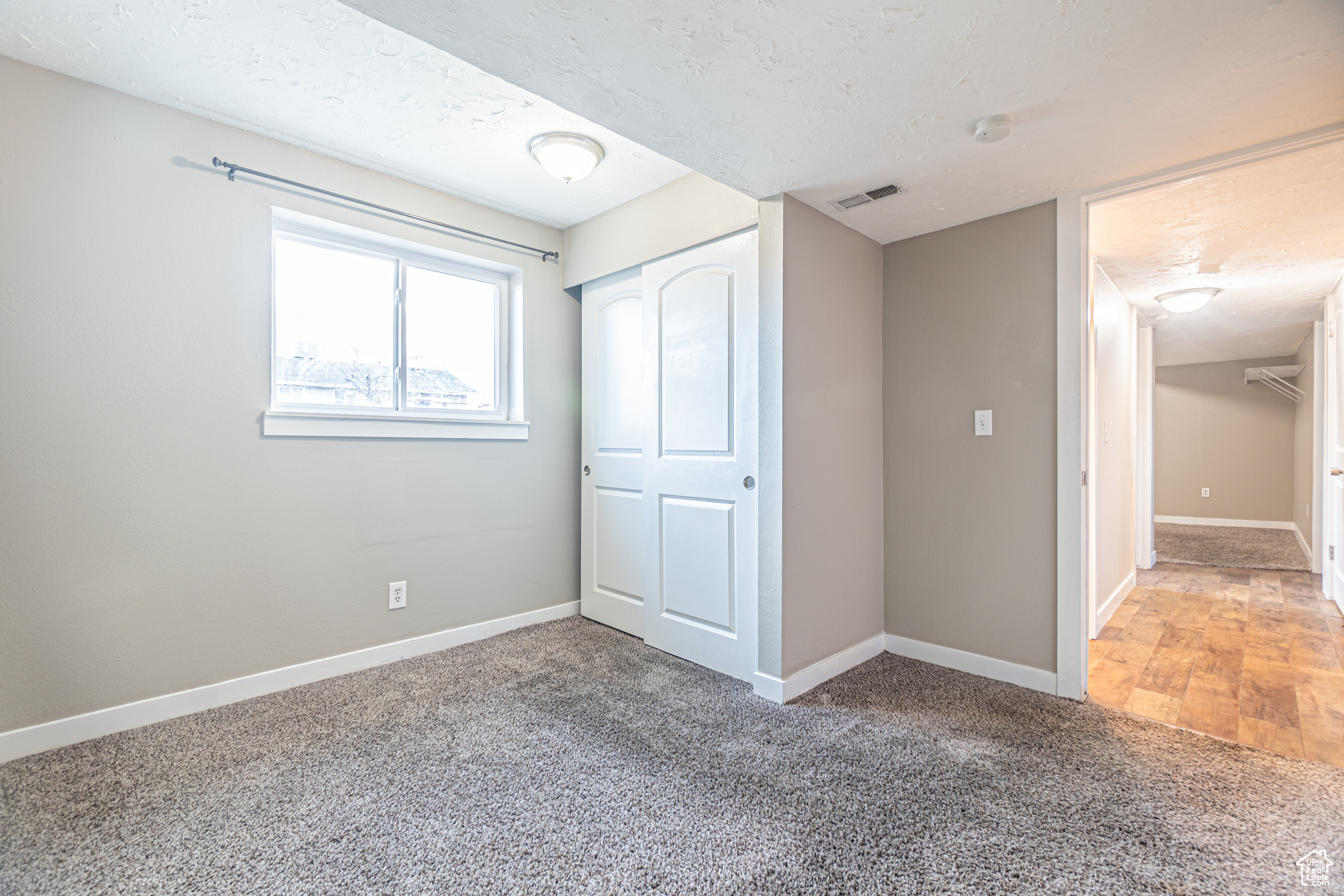 Unfurnished bedroom featuring carpet floors and a closet