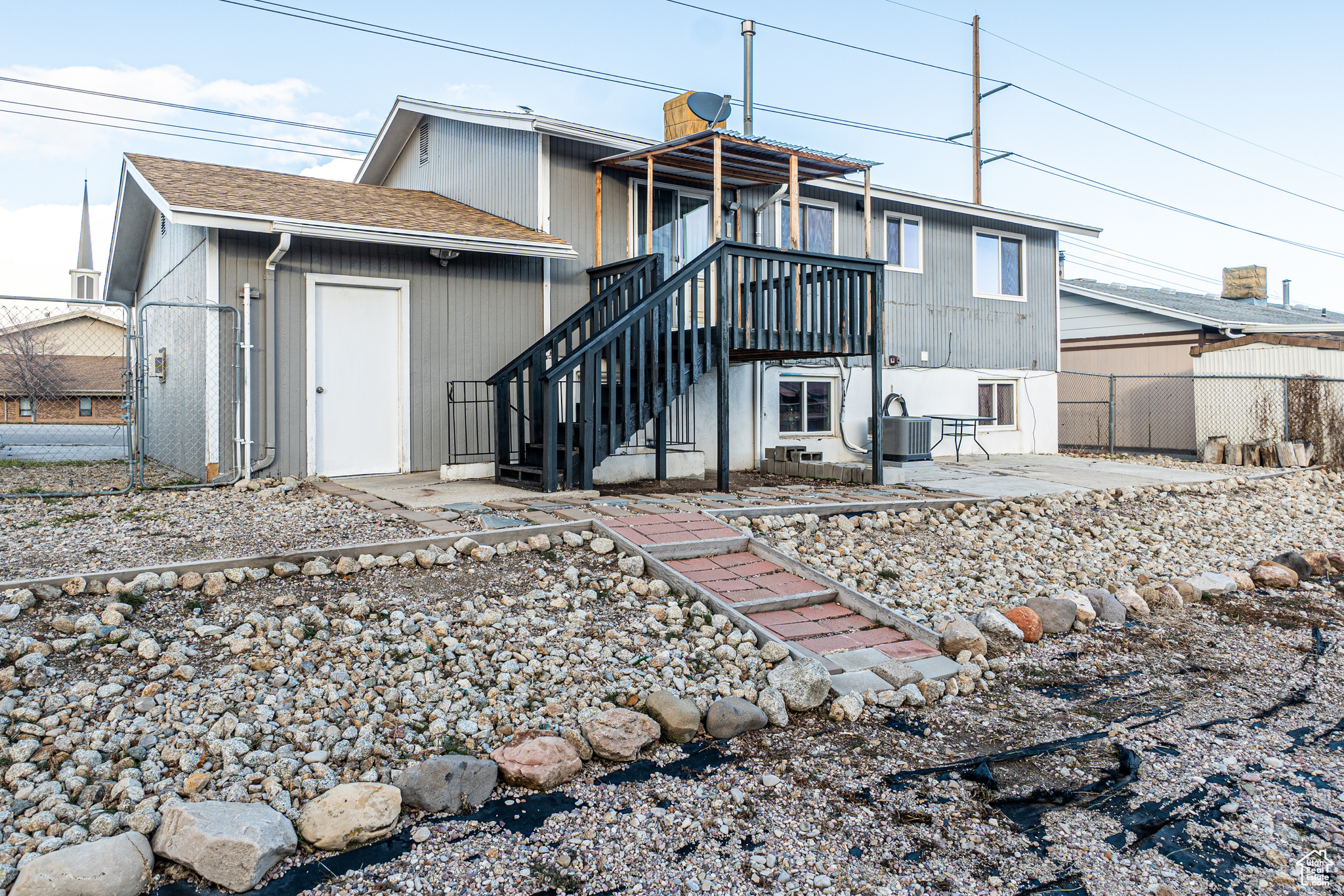 Back of property featuring central AC