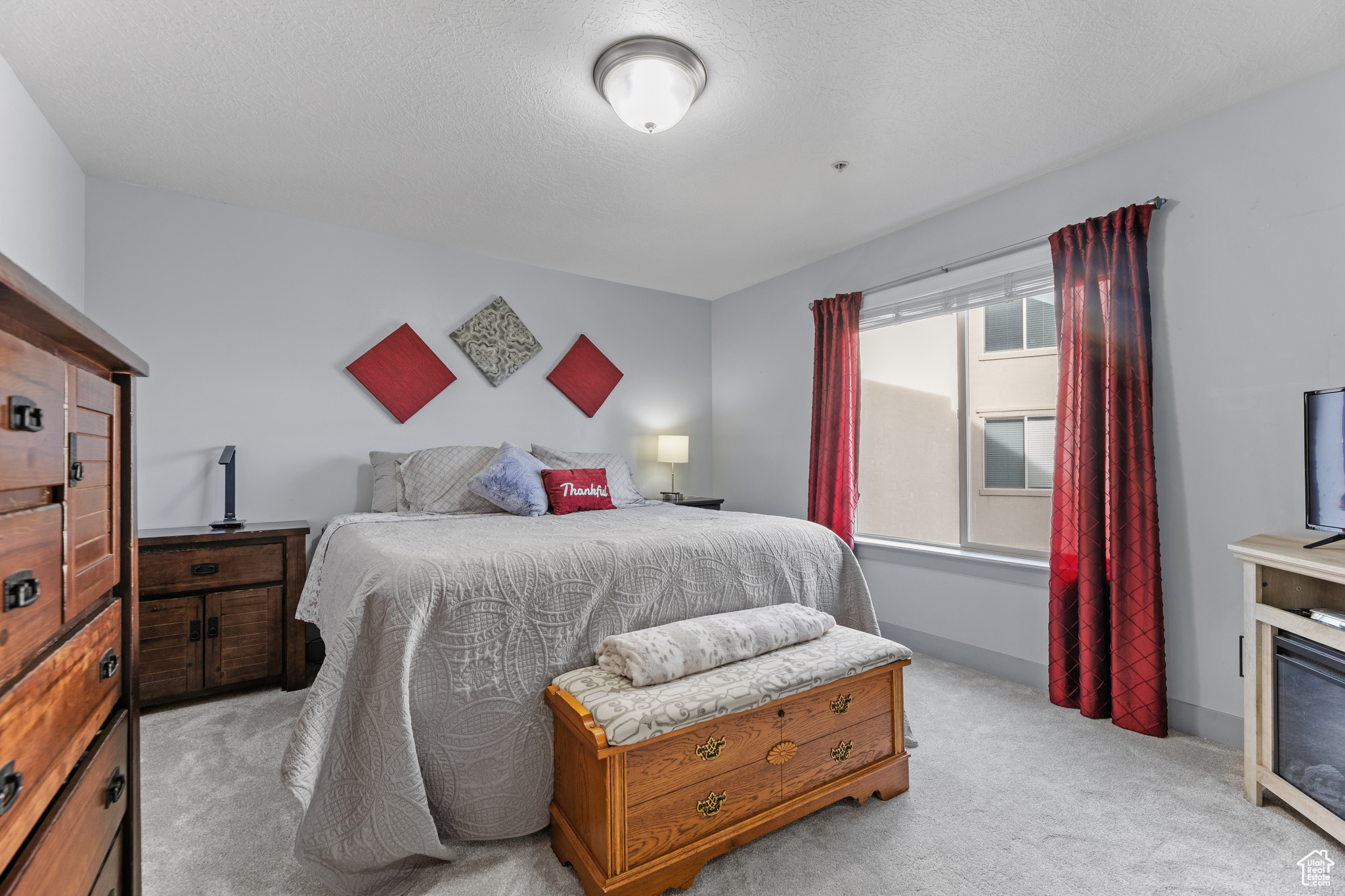 Carpeted bedroom with multiple windows