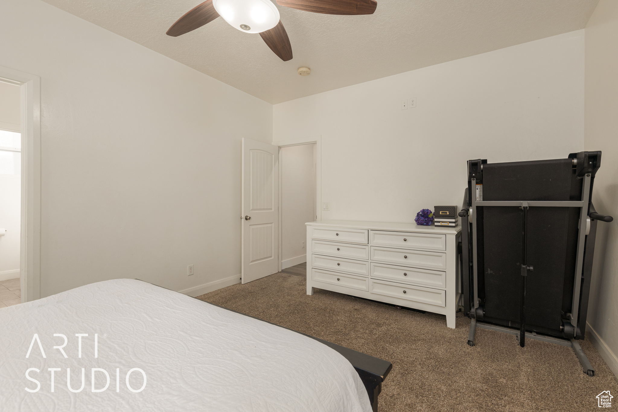 Carpeted bedroom with ceiling fan