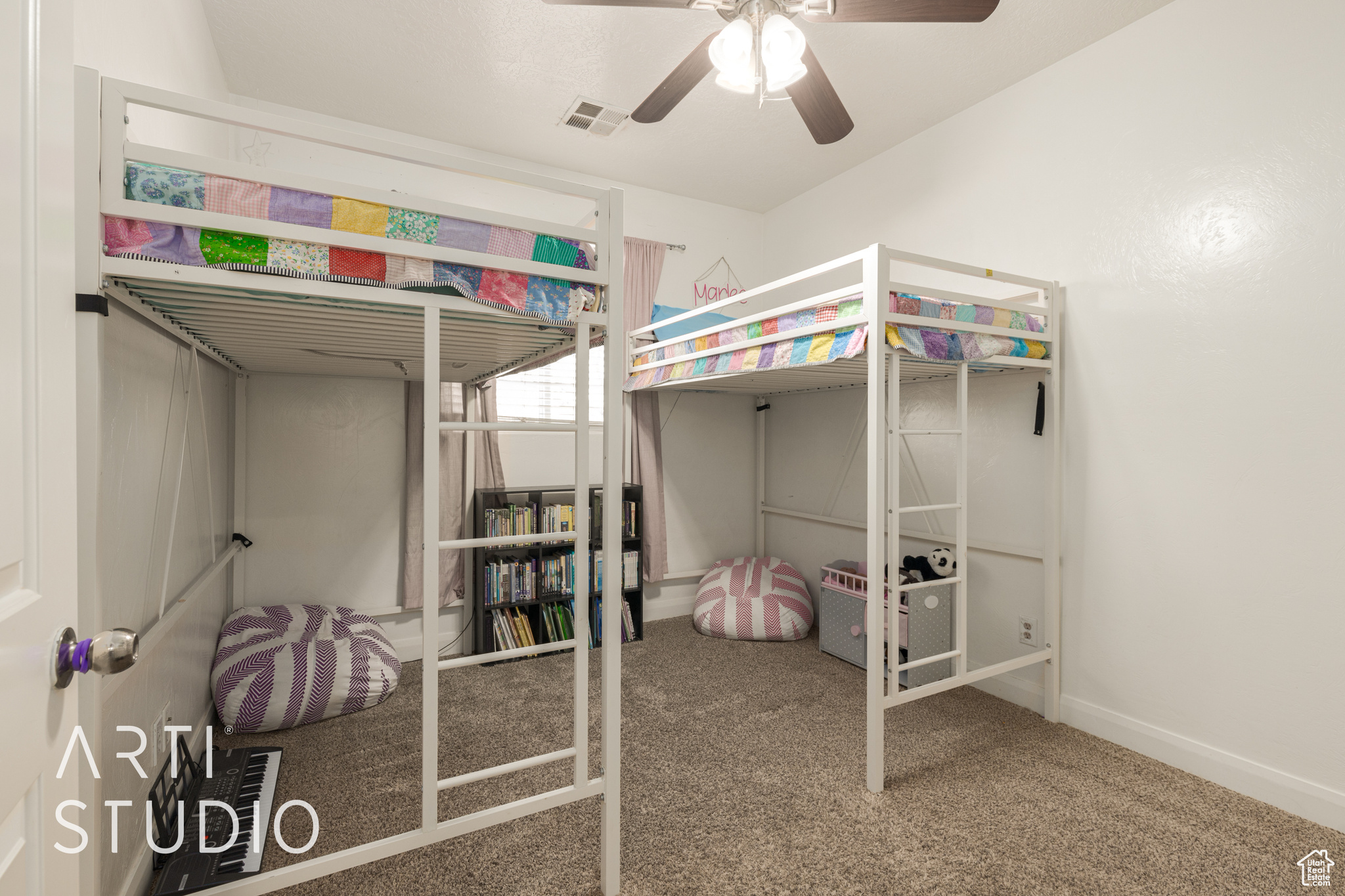 Bedroom featuring ceiling fan and carpet floors