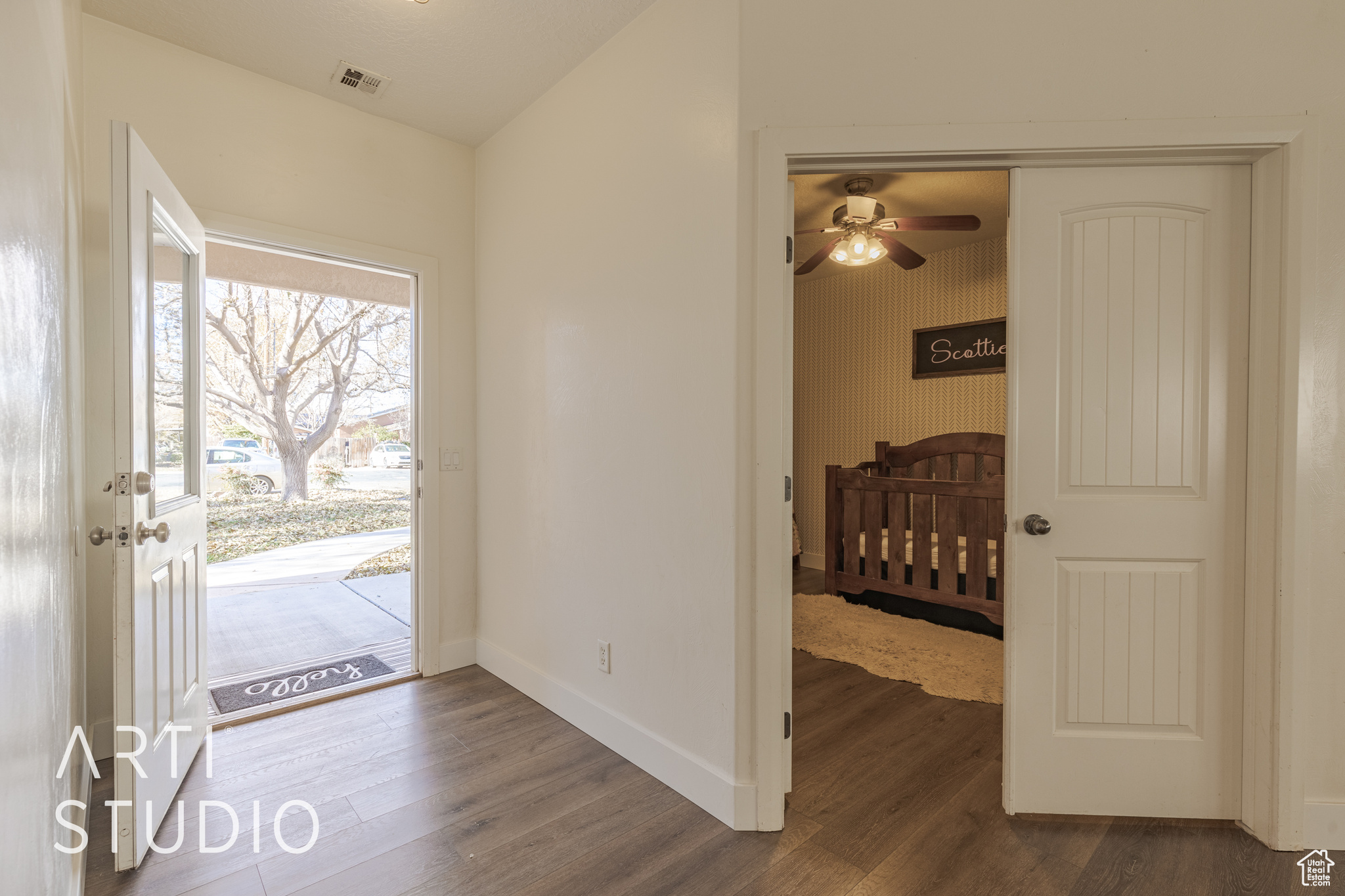 Entrance foyer with ceiling fan and dark hardwood / wood-style floors