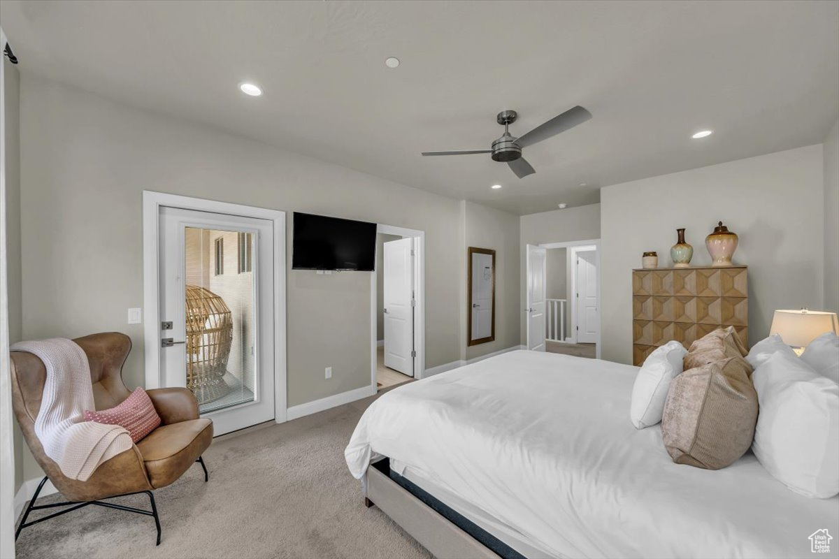 Bedroom with ceiling fan, light colored carpet, and access to outside