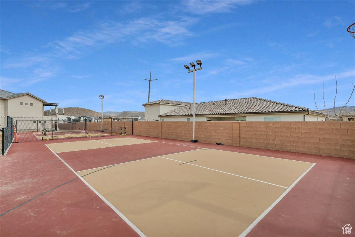 View of tennis court featuring basketball court