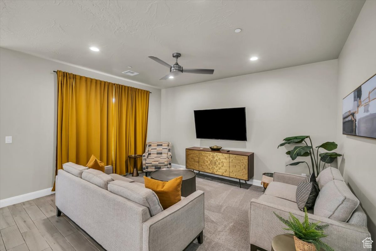 Living room featuring ceiling fan and light wood-type flooring