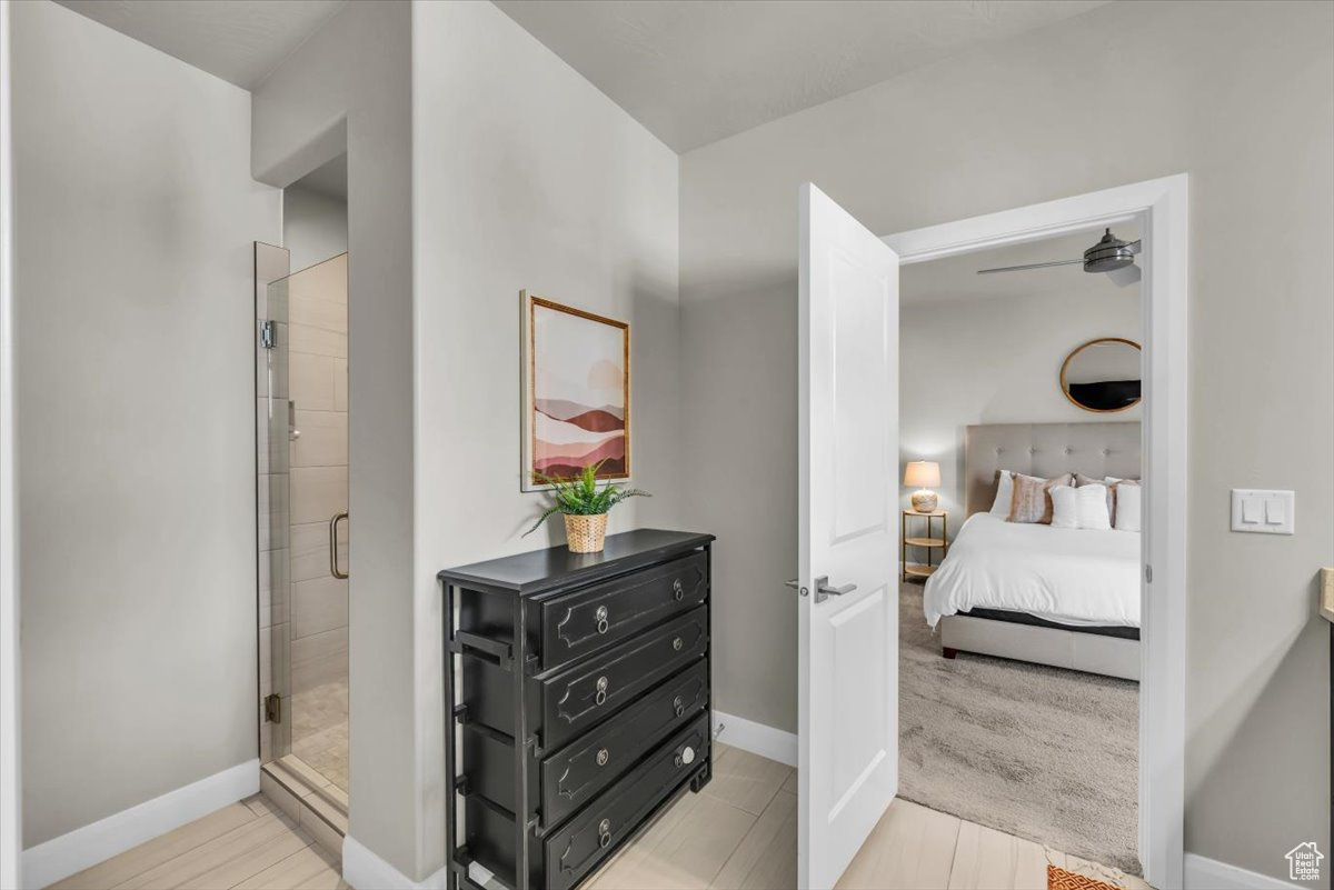 Bathroom with ceiling fan and a shower with shower door