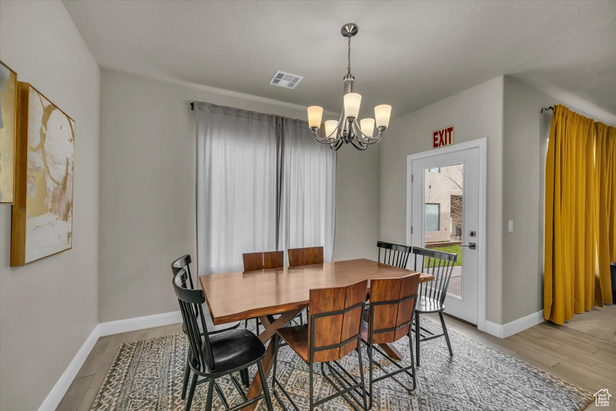 Dining area featuring a chandelier and light hardwood / wood-style flooring