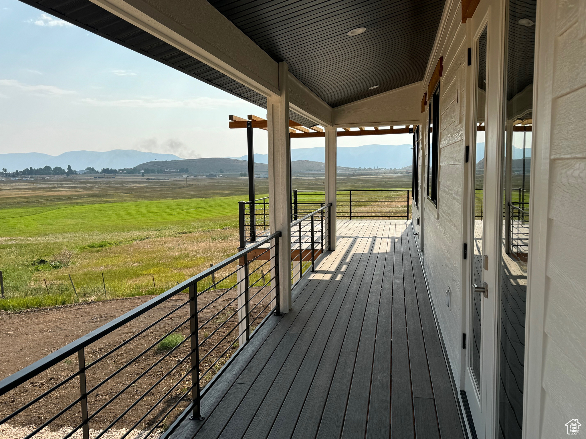 Deck with a mountain view and a rural view