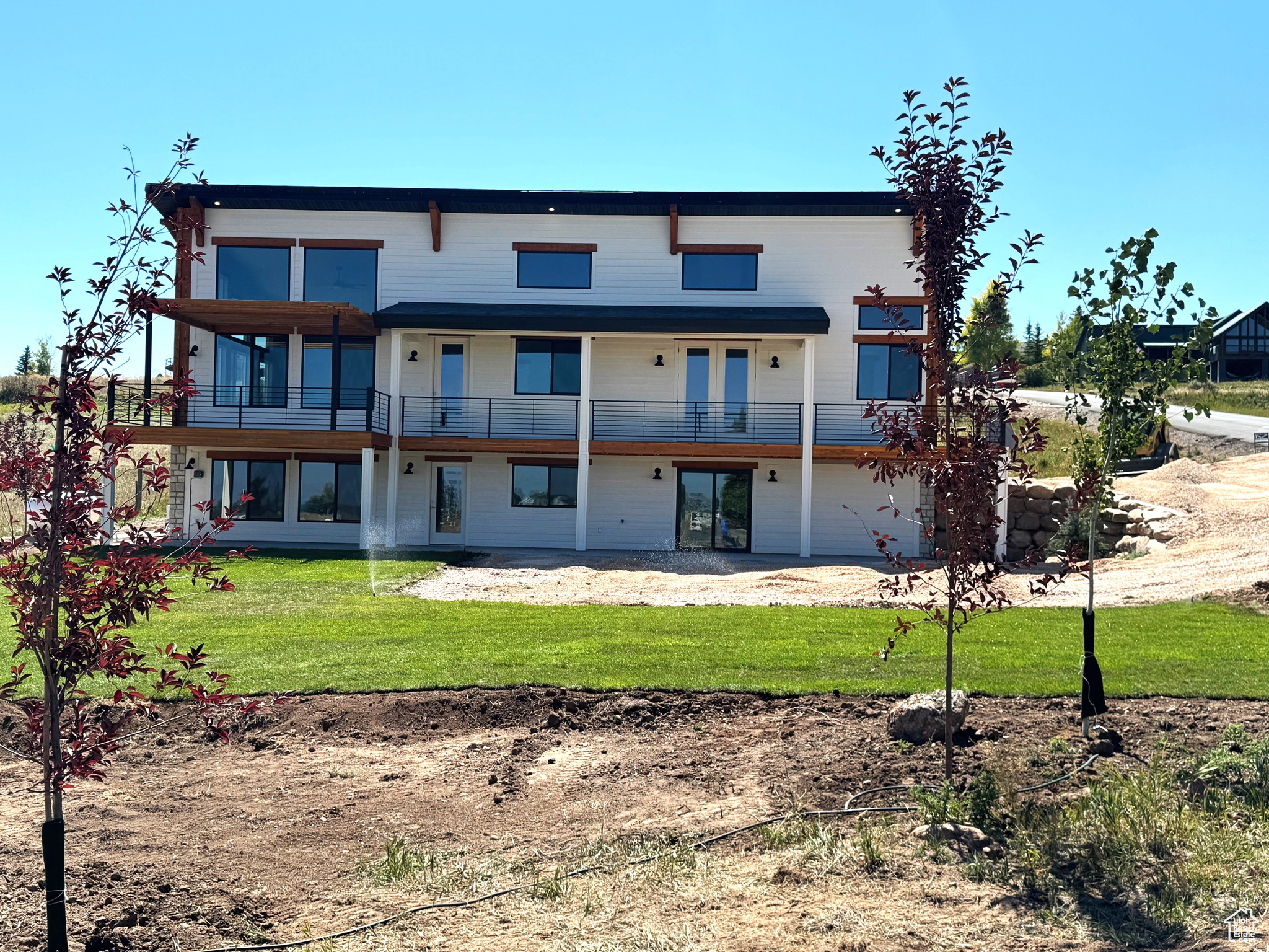 Rear view of house with a yard and a garage