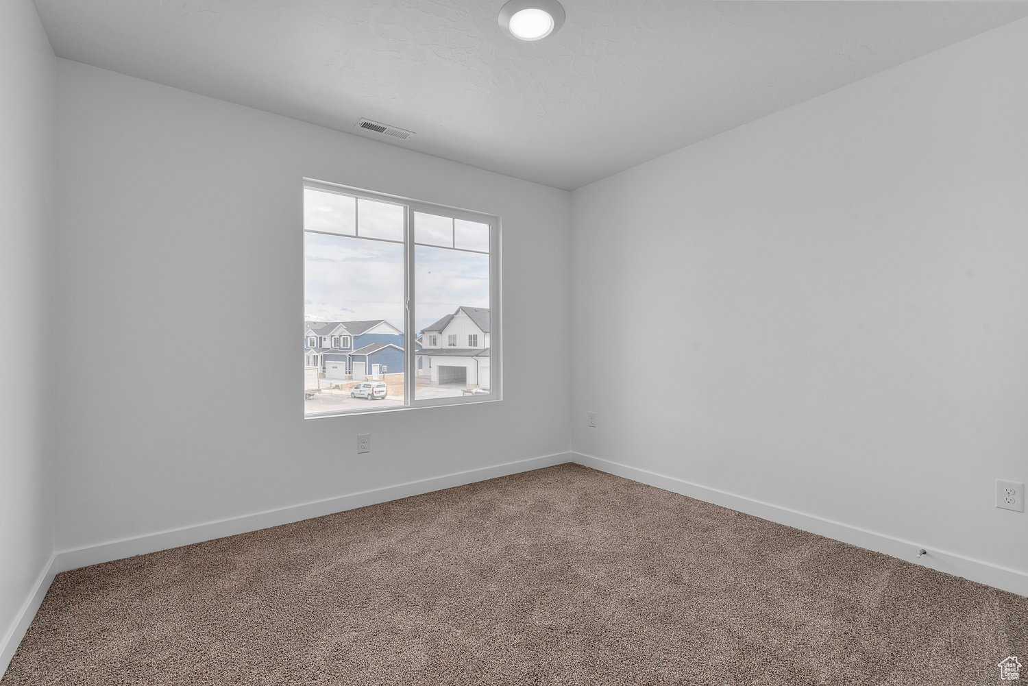 View of carpeted spare room