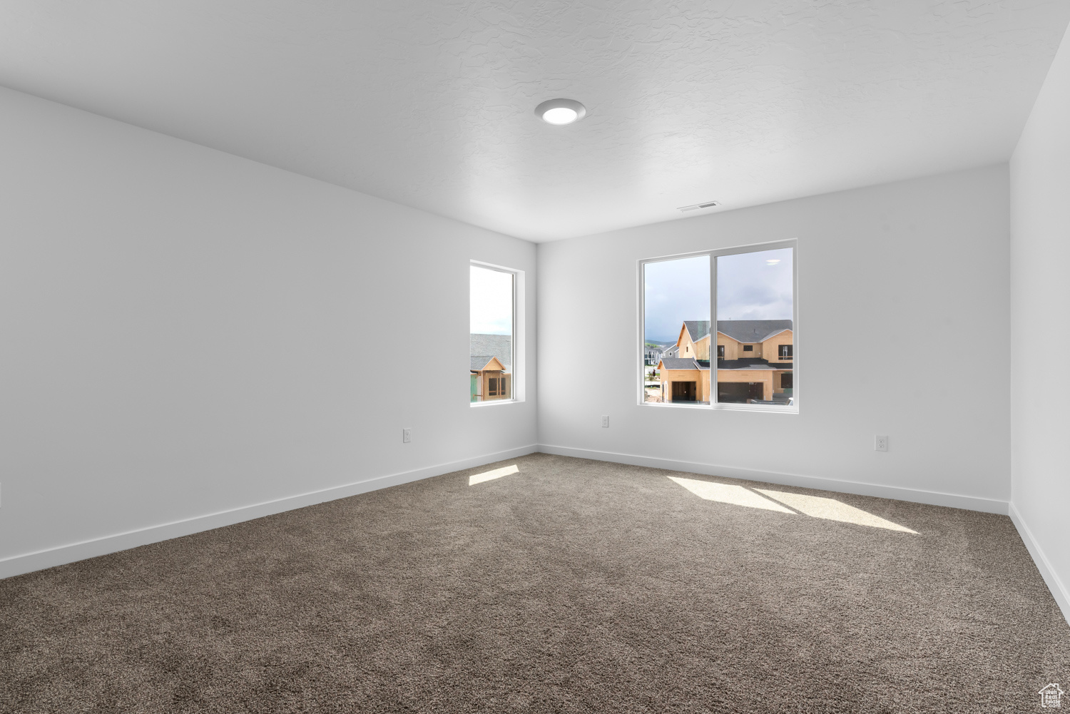 View of carpeted spare room