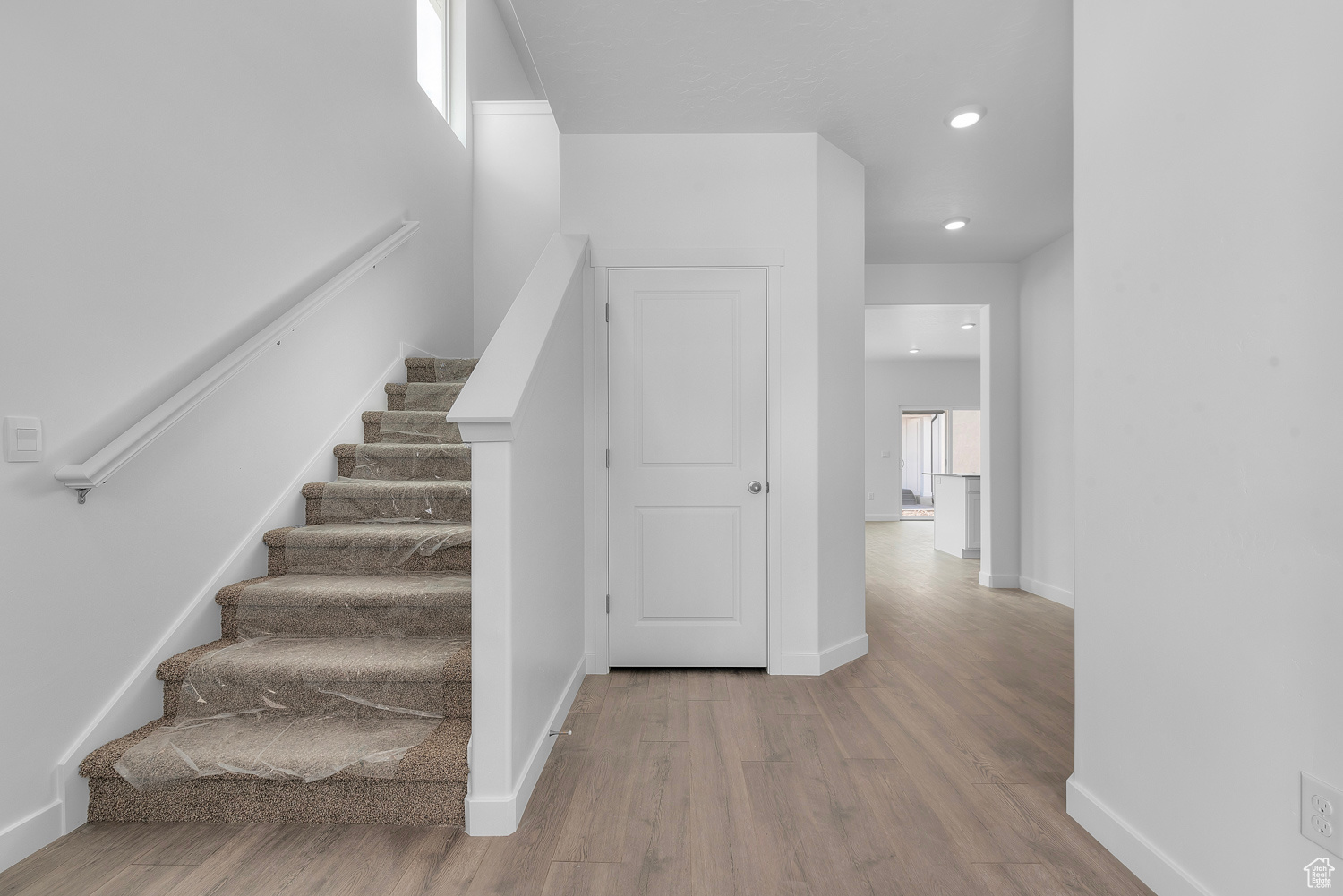 Stairs with hardwood / wood-style flooring