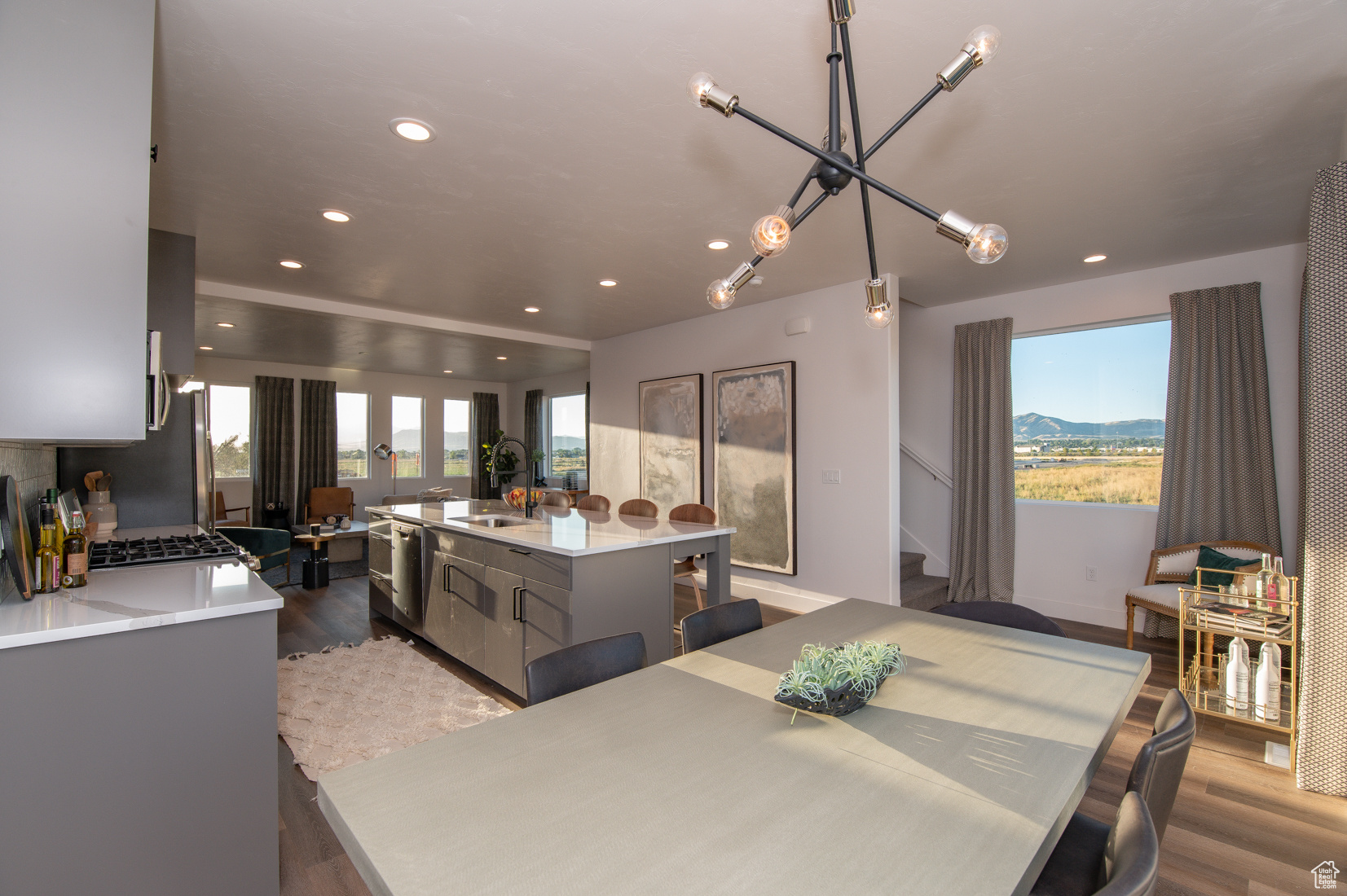 Pics are of model home.Dining room with a mountain view, hardwood / wood-style floors, a wealth of natural light, and sink