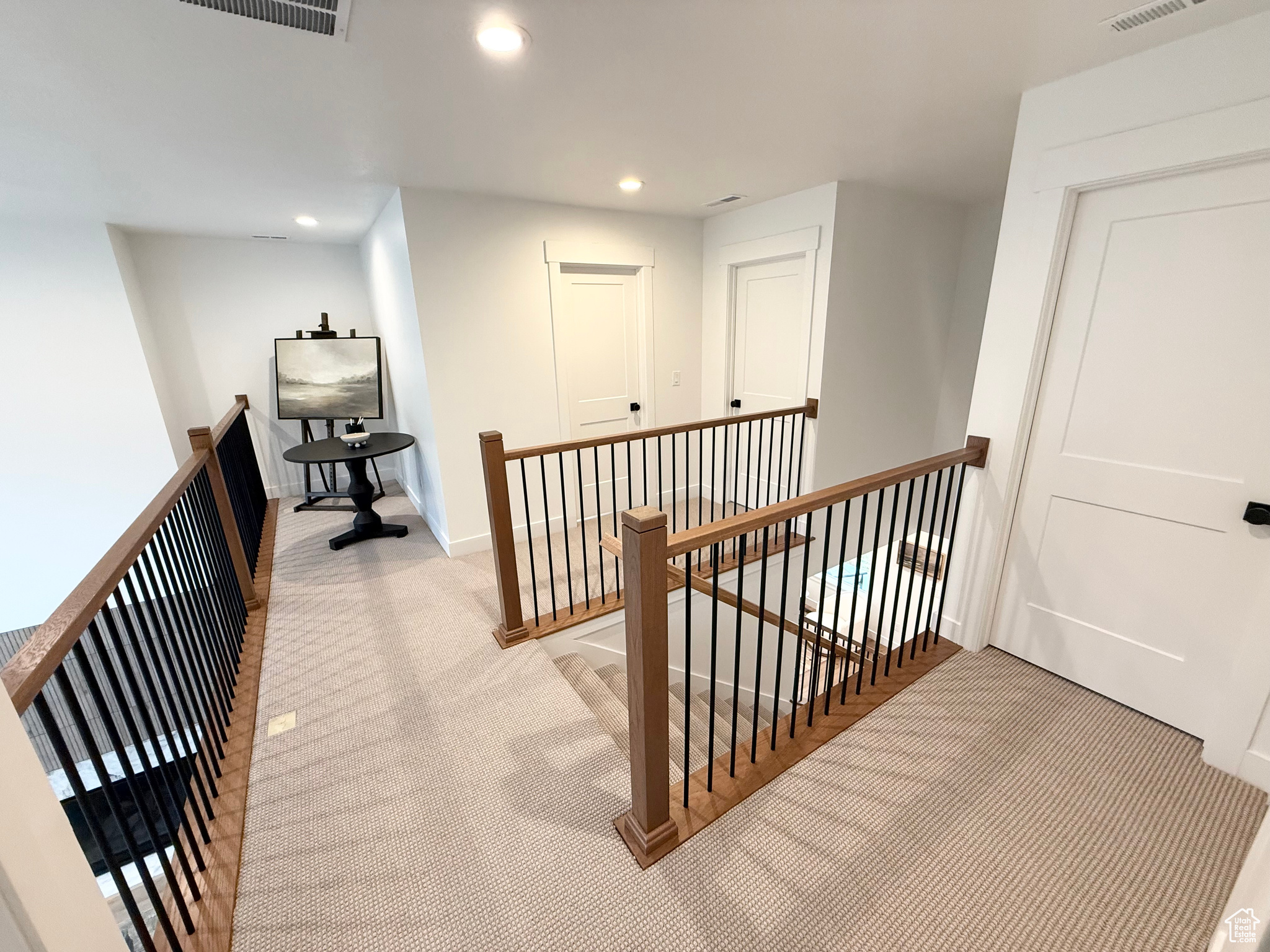 Corridor with light colored carpet