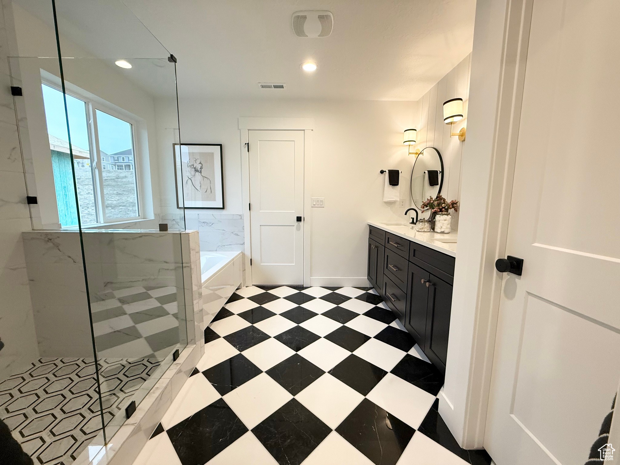 Bathroom featuring vanity and independent shower and bath