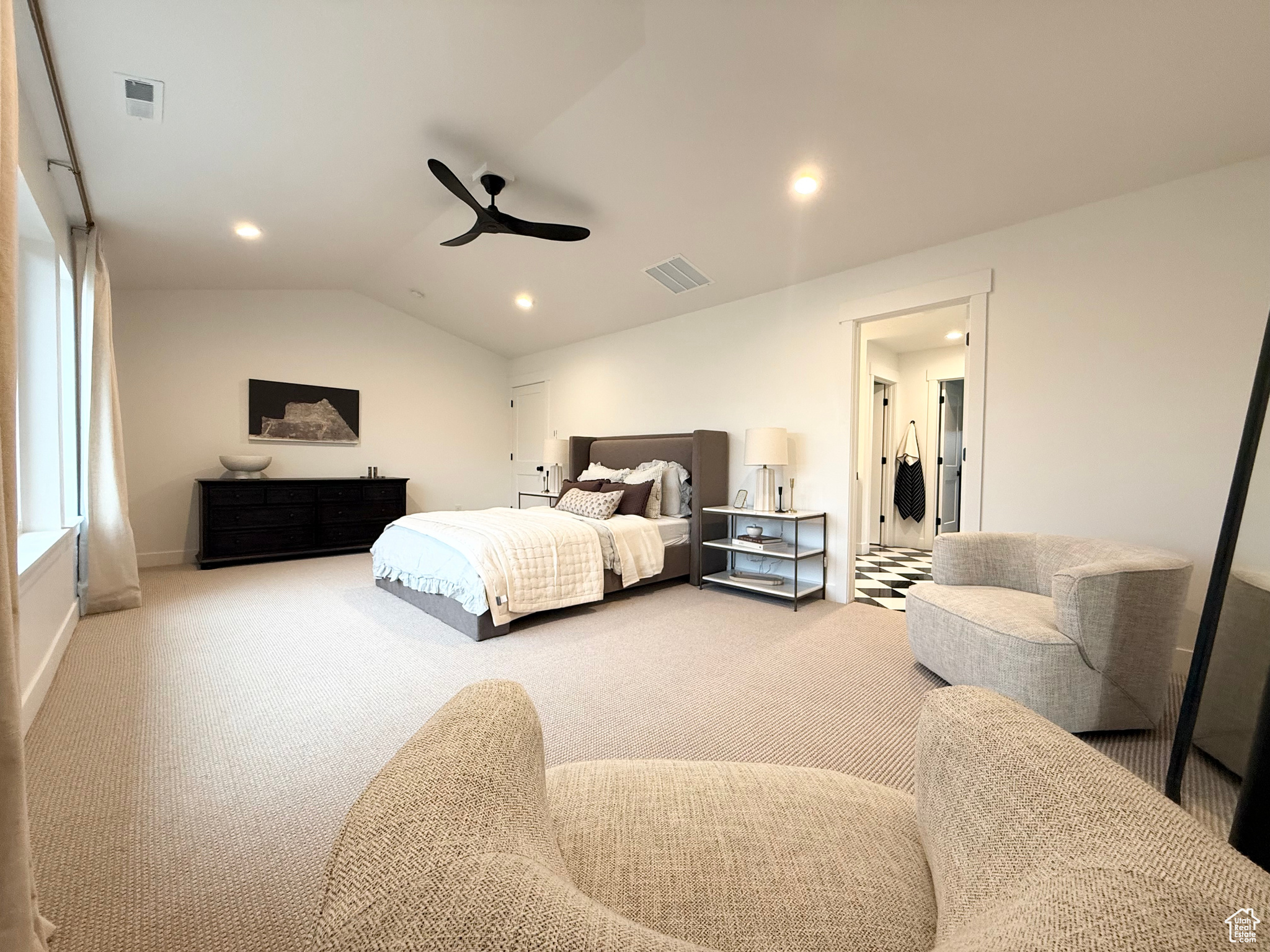 Bedroom with ceiling fan, carpet floors, and vaulted ceiling