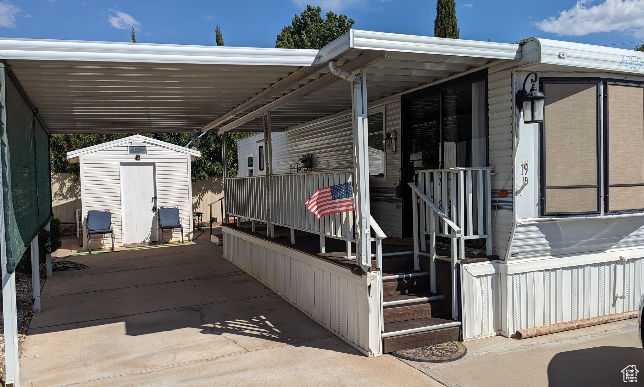 Exterior space with a carport and a storage shed