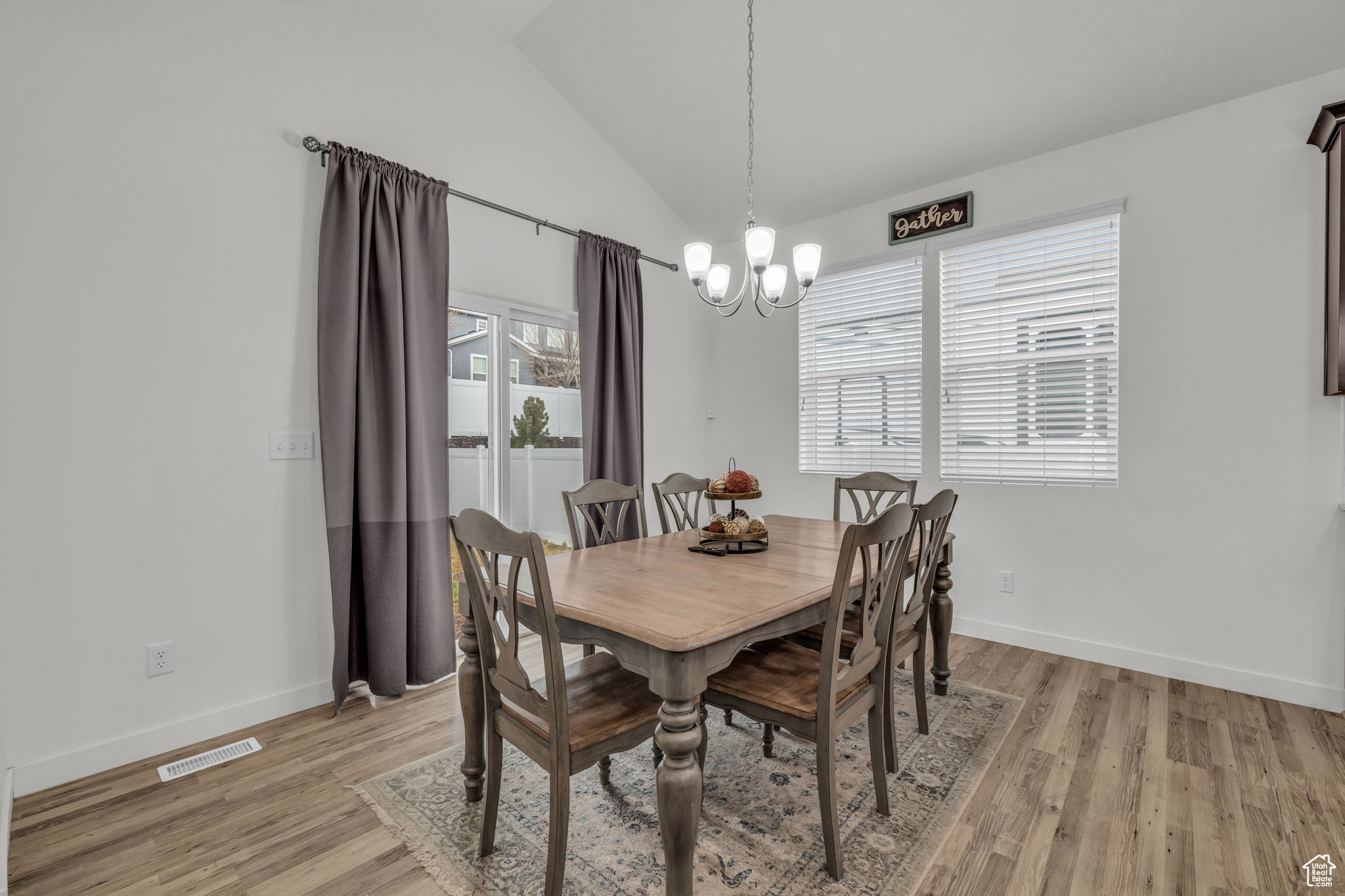 Dining room w/ vaulted ceiling w/ LVP style flooring