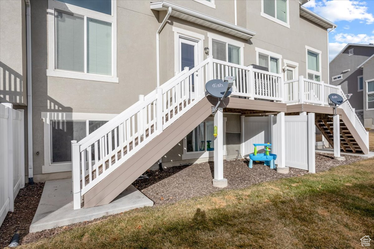 Rear view of property with a yard