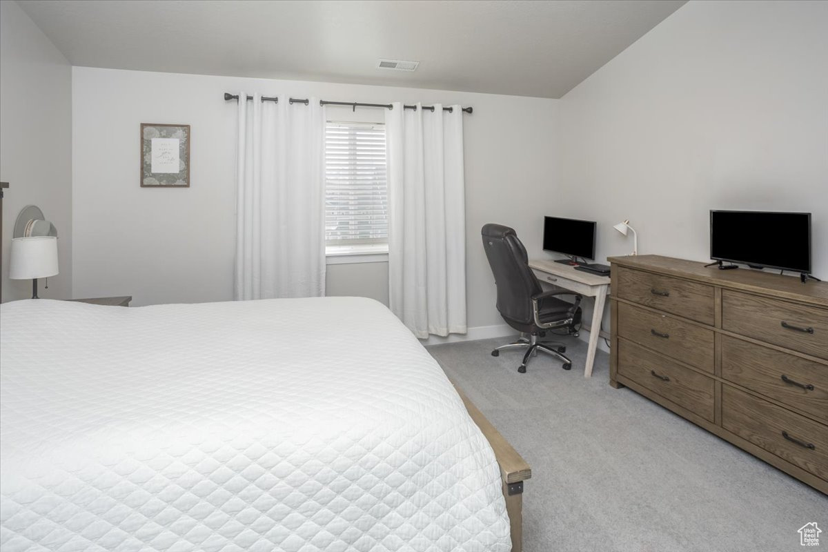 Bedroom with light carpet