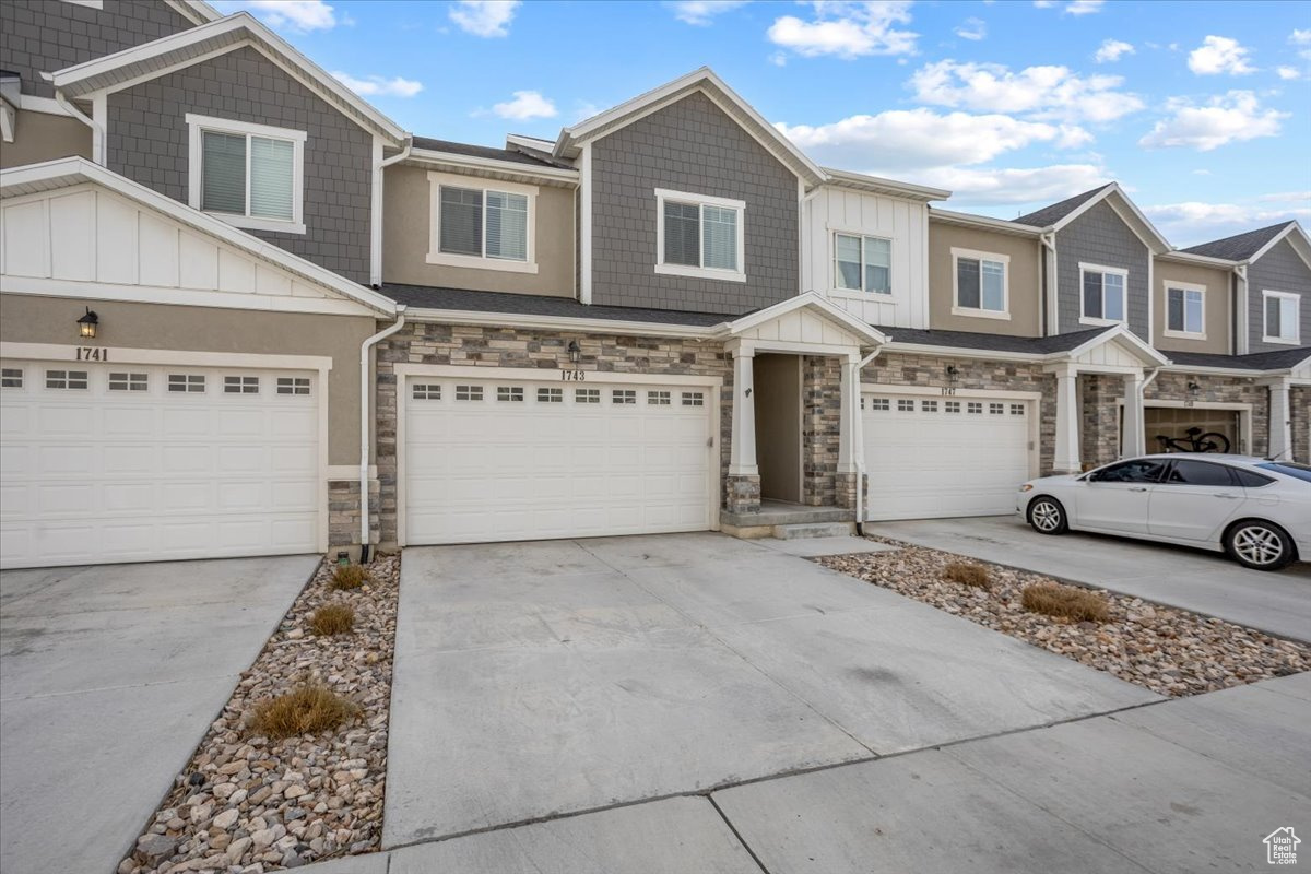 Townhome / multi-family property featuring a garage