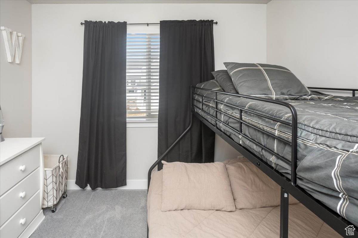 Carpeted bedroom with multiple windows