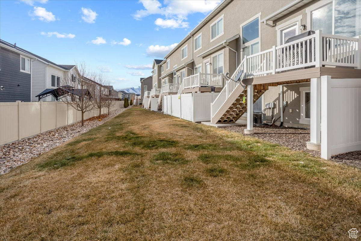 View of yard with cooling unit and a wooden deck