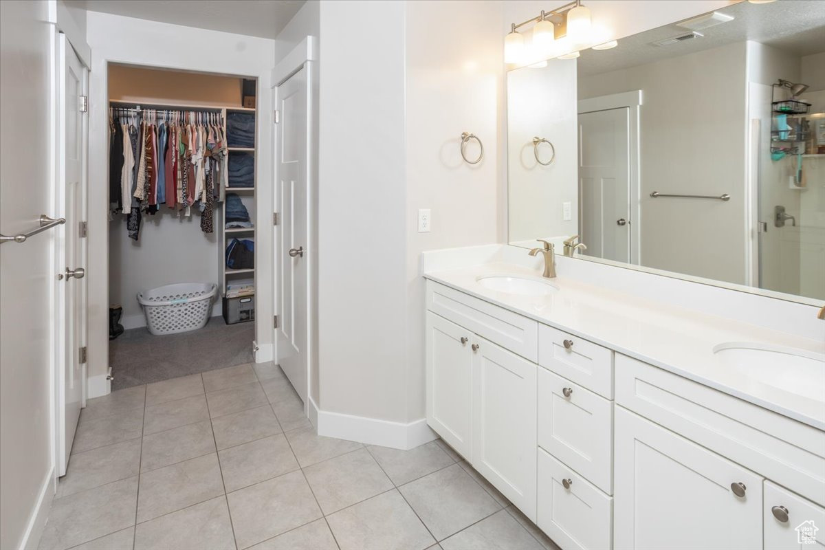 Bathroom featuring tile patterned flooring and vanity