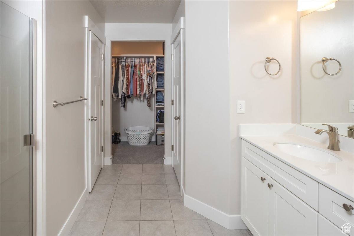 Bathroom featuring tile patterned flooring and vanity