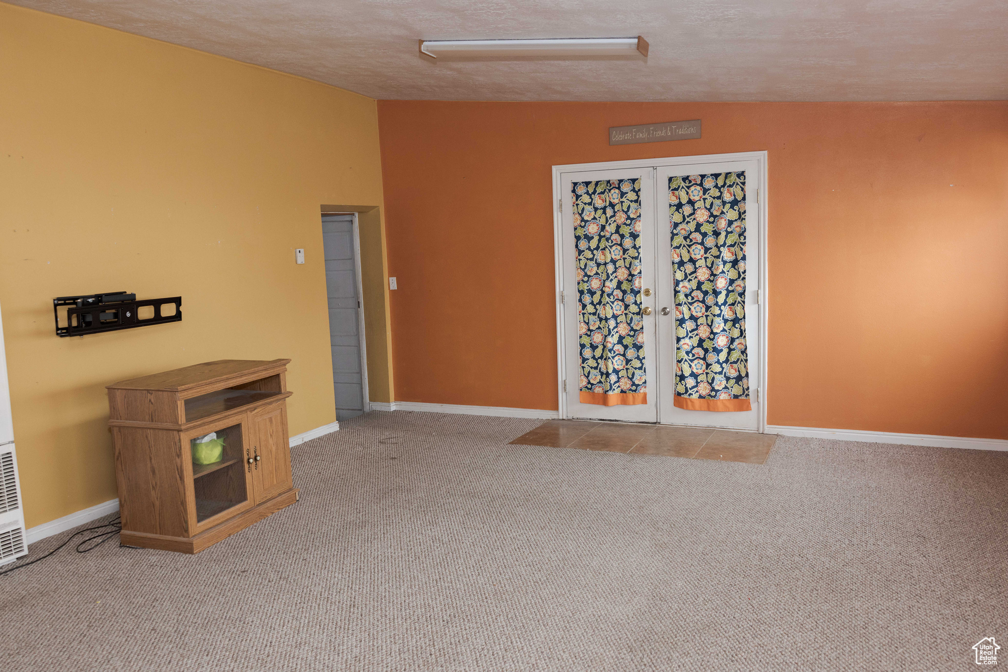 Interior space featuring carpet flooring, a textured ceiling, and vaulted ceiling