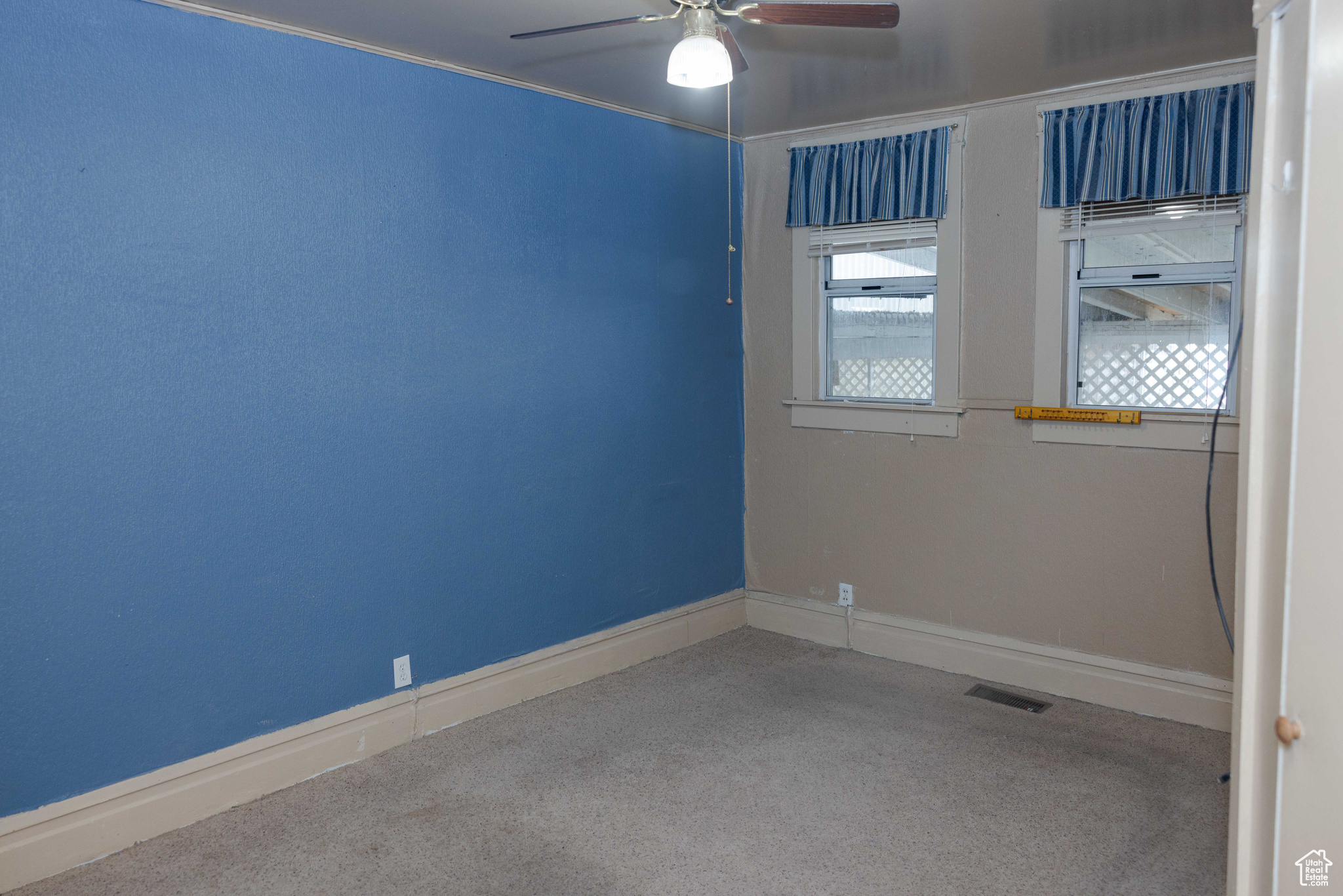 Empty room featuring carpet and ceiling fan